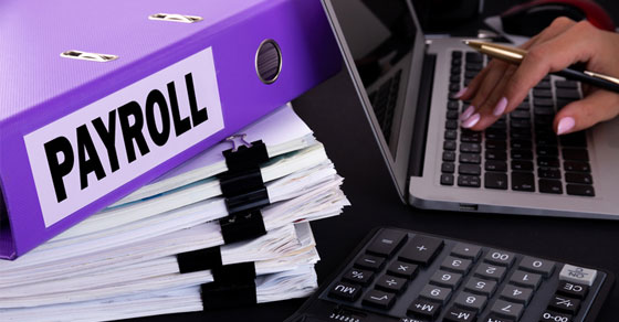 Payroll tax binder on desk